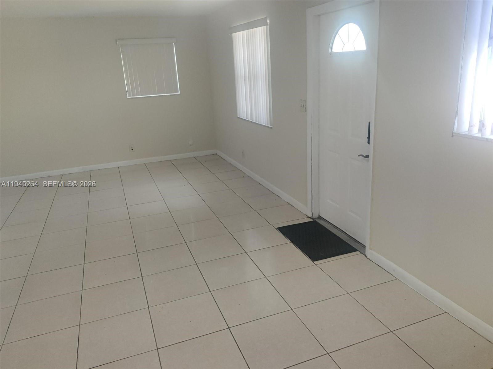 844 Southwest 10th Street Hallandale Beach, FL 33009 - Photo 12 of 18 an empty room with windows