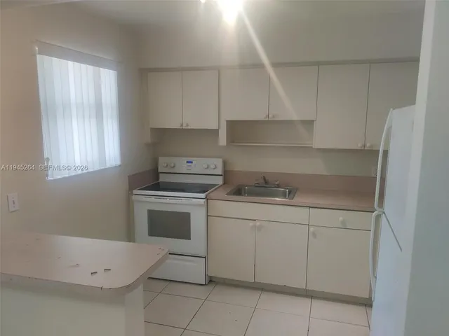 a white refrigerator freezer sitting inside of a kitchen