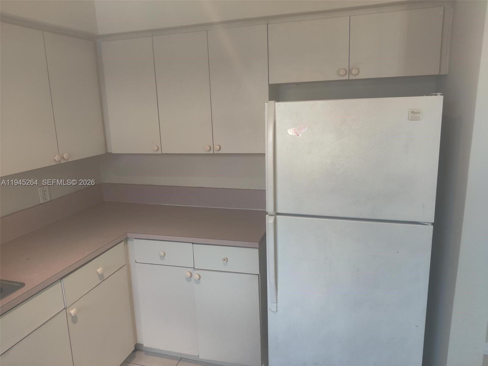 844 Southwest 10th Street Hallandale Beach, FL 33009 - Photo 17 of 18 a white refrigerator freezer sitting inside of a kitchen