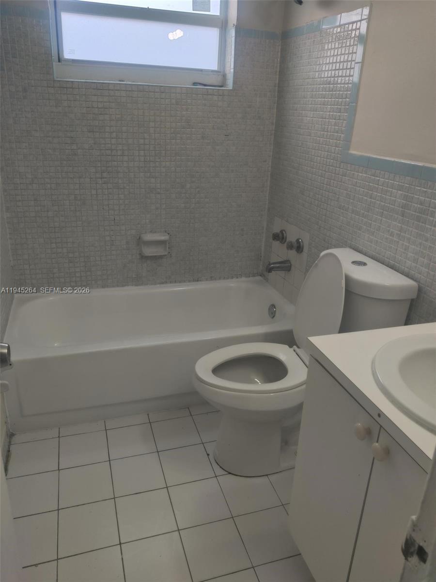 844 Southwest 10th Street Hallandale Beach, FL 33009 - Photo 18 of 18 a bathroom with a toilet a sink and bathtub