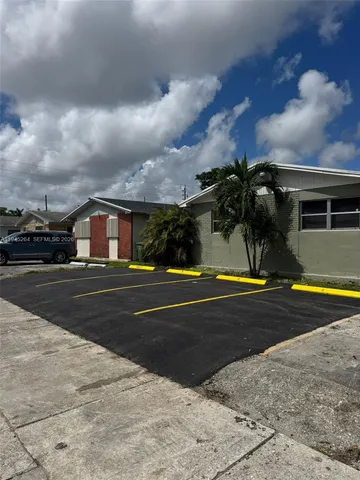 a view of street with yellow house