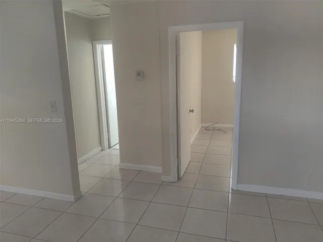 a view of an empty room with a bathroom
