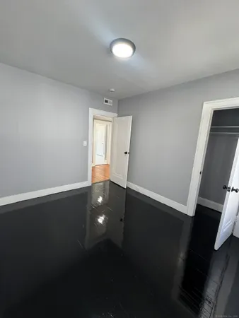 a view of an empty room and wooden floor