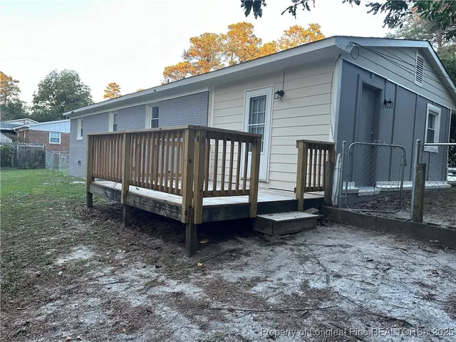 a view of a small house with a yard