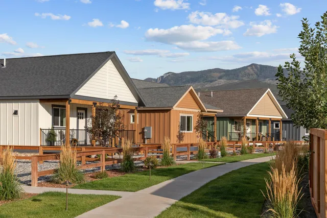a front view of a house with a yard table and chairs