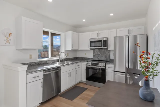 a kitchen with a sink stove and refrigerator