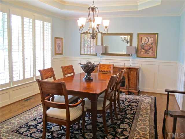 907 Shelley Road Raleigh, NC 27609 - Photo 4 of 23 a dining room with furniture a large window and wooden floor