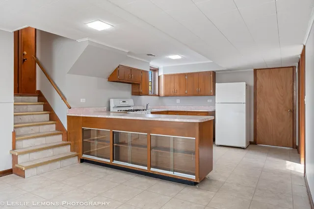 a view of kitchen with stainless steel appliances cabinets and window