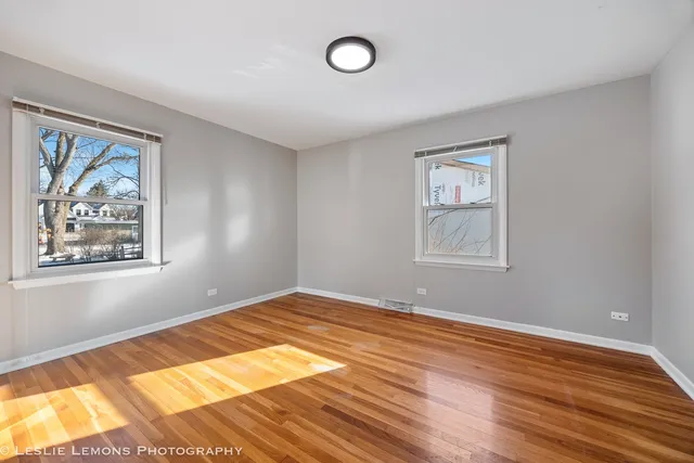 a view of a room with wooden floor and window