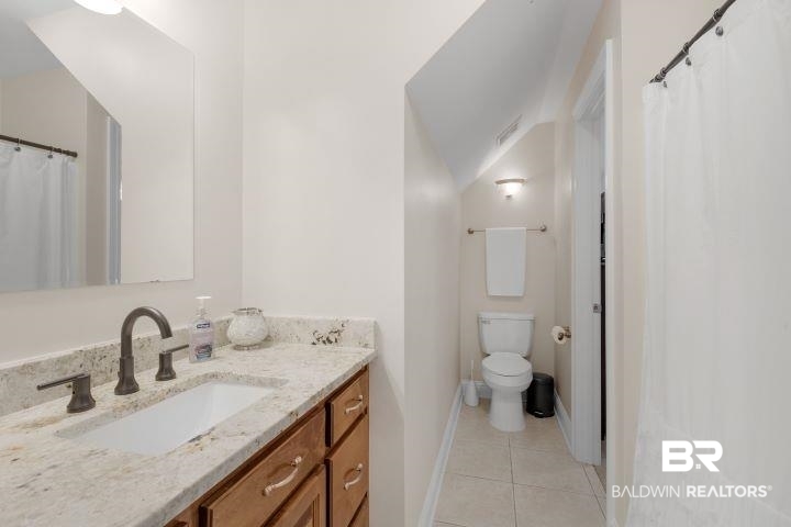 24541 Baldwin Beach Expressway Robertsdale, AL 36567 - Photo 27 of 51 Bathroom with baseboards, toilet, tile patterned flooring, and vanity