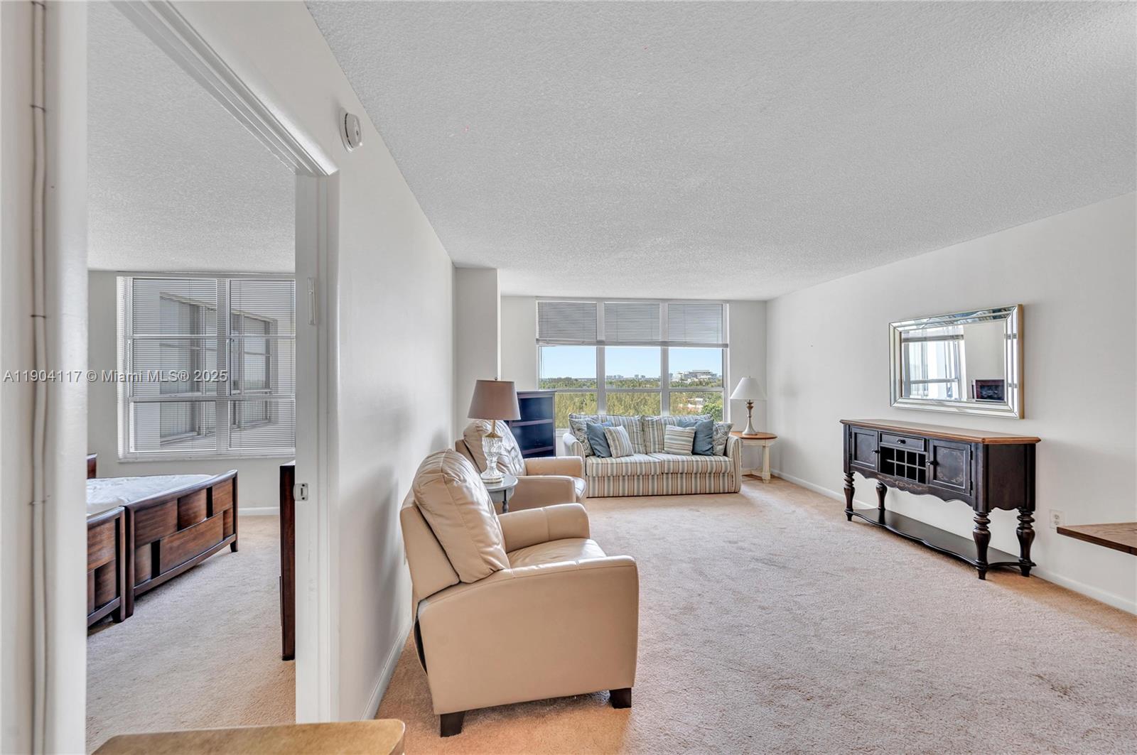 4101 Pine Tree Drive, Unit 707 Miami Beach, FL 33140 - Photo 11 of 41 a living room with furniture and a window