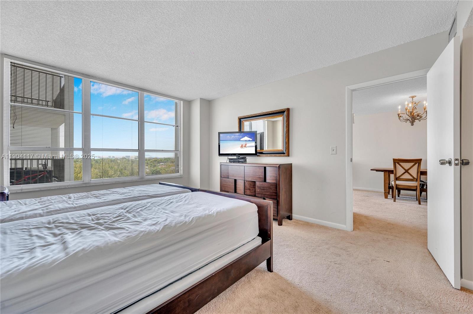 4101 Pine Tree Drive, Unit 707 Miami Beach, FL 33140 - Photo 12 of 41 a bedroom with a bed and a large window