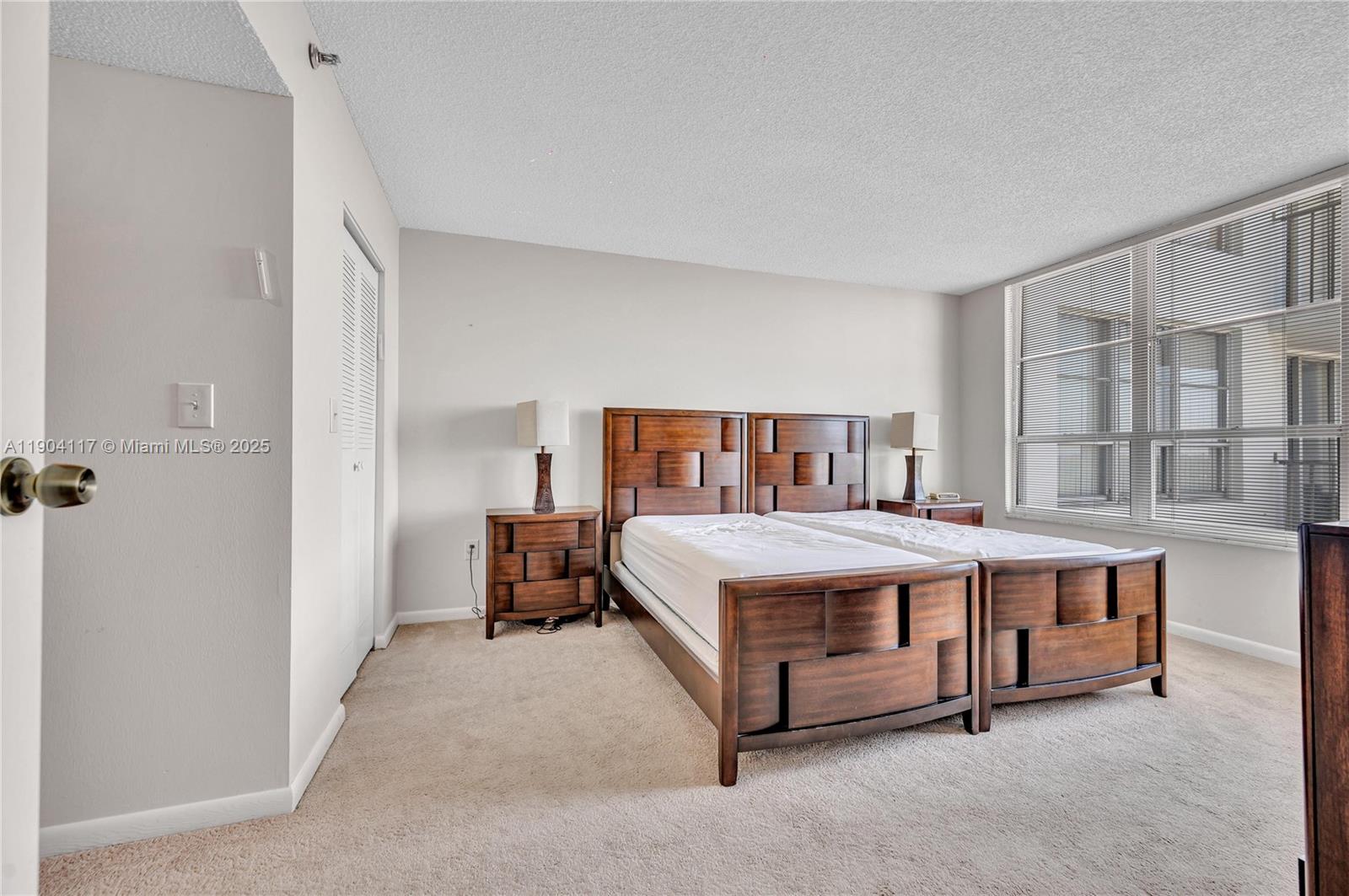 4101 Pine Tree Drive, Unit 707 Miami Beach, FL 33140 - Photo 13 of 41 a bed room with a bed and a table