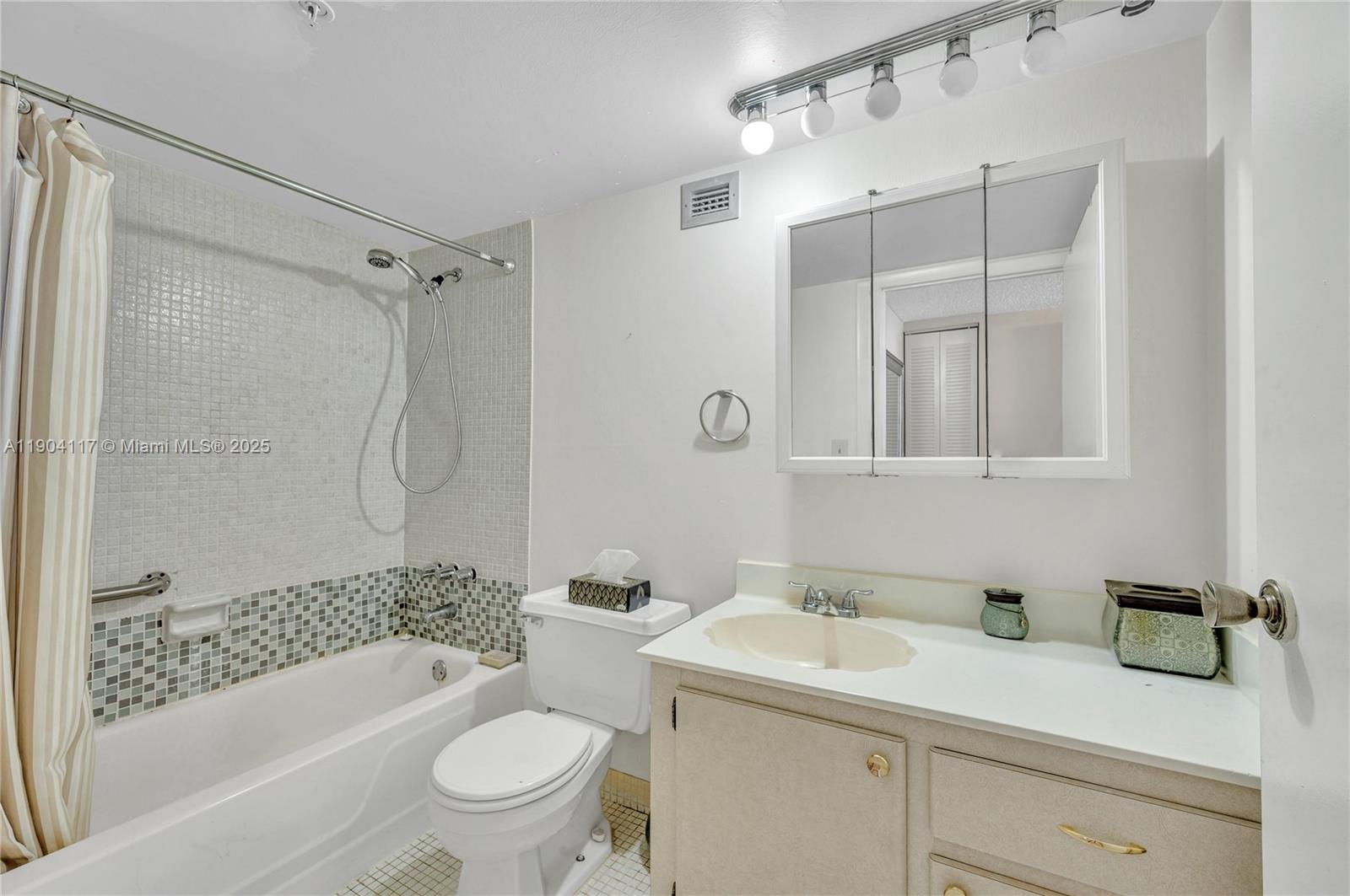 4101 Pine Tree Drive, Unit 707 Miami Beach, FL 33140 - Photo 16 of 41 a bathroom with a sink a toilet and shower