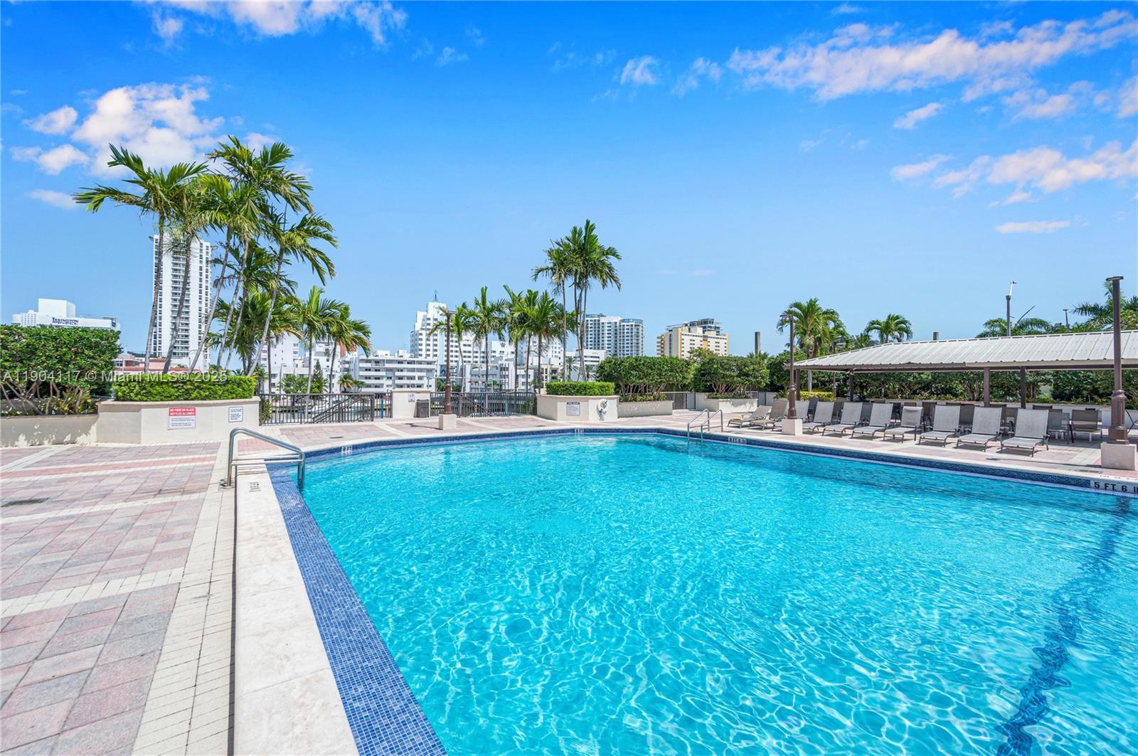 4101 Pine Tree Drive, Unit 707 Miami Beach, FL 33140 - Photo 28 of 41 a view of a swimming pool and a terrace