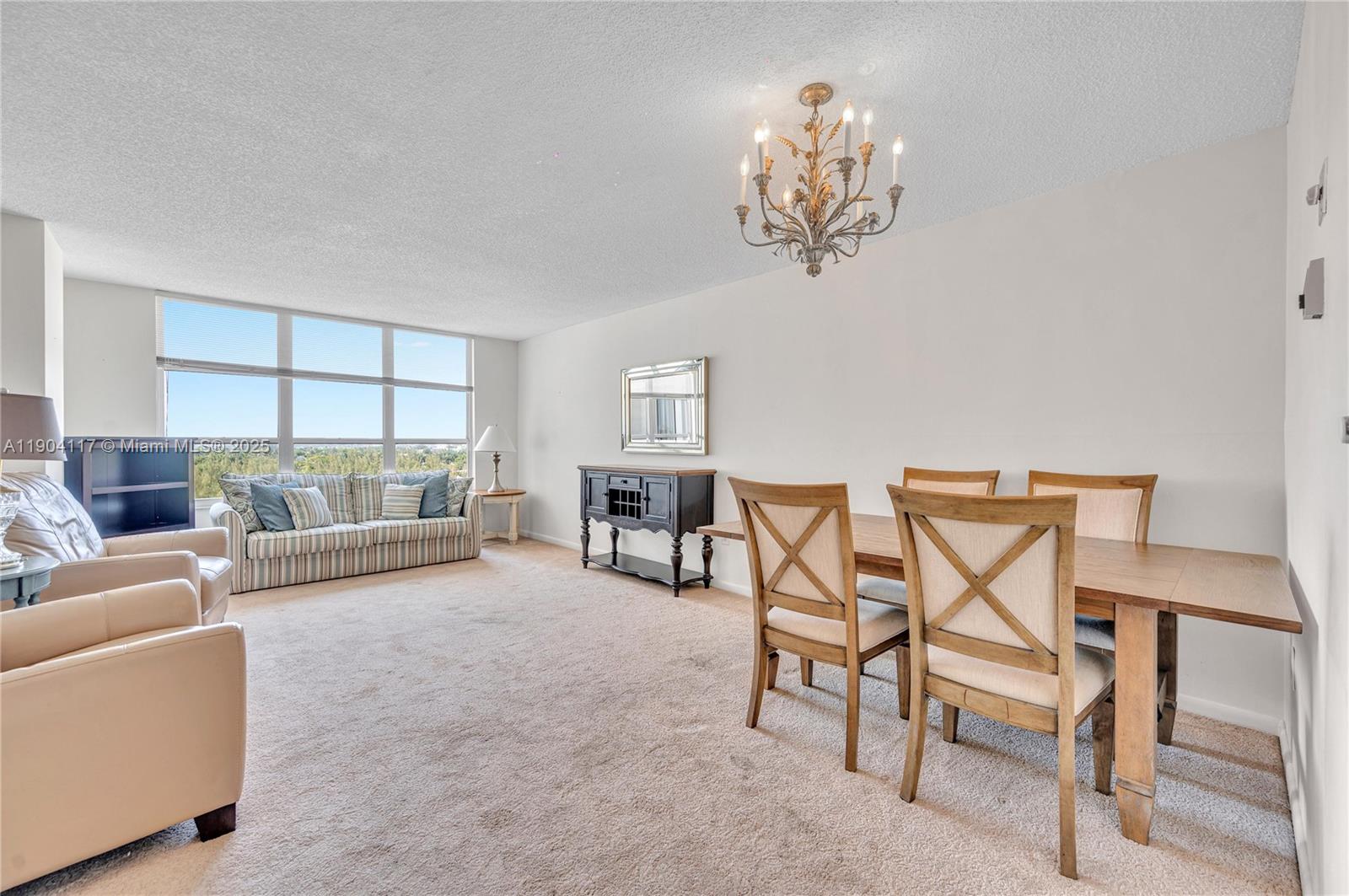 4101 Pine Tree Drive, Unit 707 Miami Beach, FL 33140 - Photo 3 of 41 a view of a livingroom with furniture and a chandelier