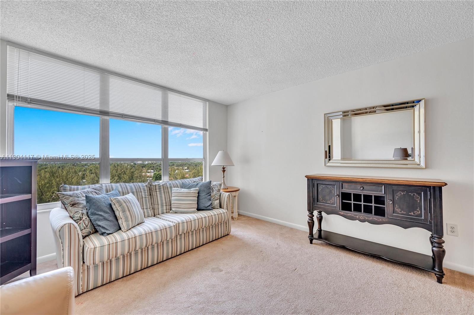 4101 Pine Tree Drive, Unit 707 Miami Beach, FL 33140 - Photo 4 of 41 a living room with furniture and a window