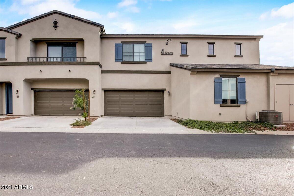 3900 East Baseline Road, Unit 127 Phoenix, AZ 85042 - Photo 34 of 60 a front view of a house with a yard and garage