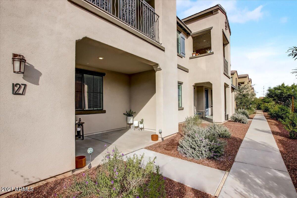 3900 East Baseline Road, Unit 127 Phoenix, AZ 85042 - Photo 5 of 60 a view of a white house with many windows next to a road