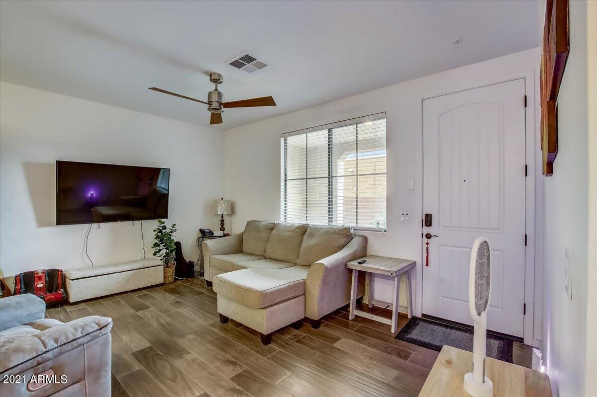 3900 East Baseline Road, Unit 127 Phoenix, AZ 85042 - Photo 9 of 60 a living room with furniture and a flat screen tv