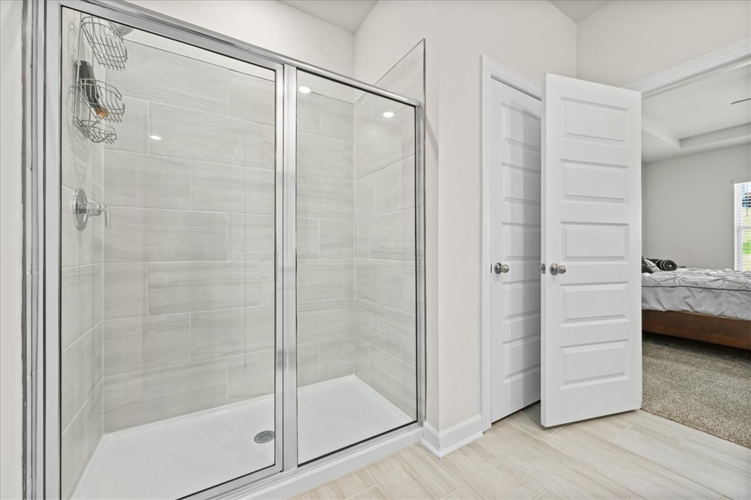 106 Purcell Way Easley, SC 29642 - Photo 19 of 39 This modern bathroom features a spacious shower and convenient access to the adjoining bedroom.