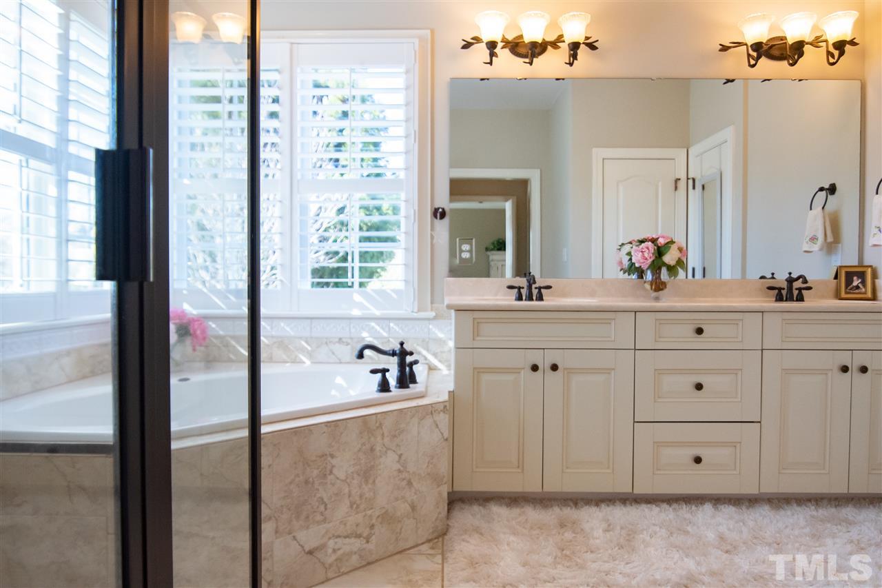 2203 Hopeton Avenue Raleigh, NC 27614 - Photo 16 of 25 Unwind from a long day in the tub or steam in the walk-in shower. Double sink vanity offers his and hers space.