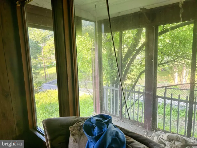 a view of a livingroom with furniture and windows