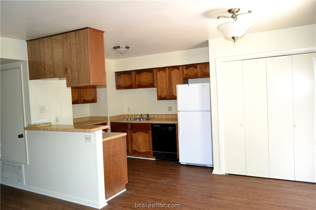 a kitchen with stainless steel appliances a refrigerator and a stove
