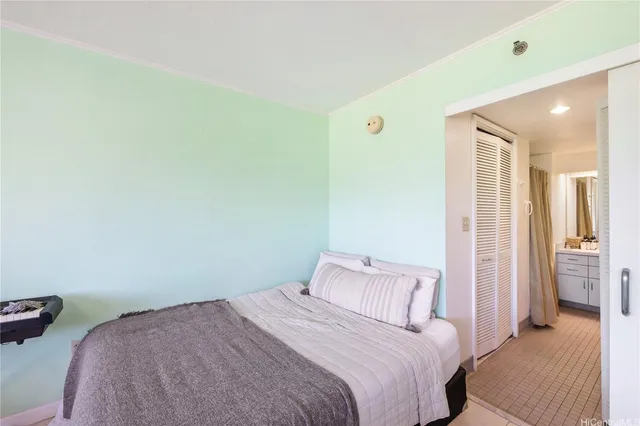 a bedroom with a bed and cabinets