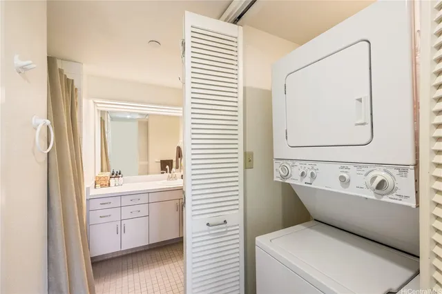 a bathroom with a double vanity sink mirror and bathtub