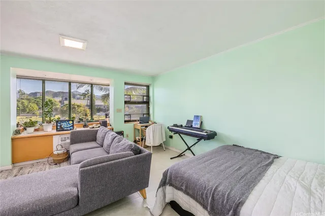 a bedroom with furniture and a window