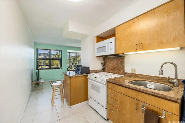 a kitchen with a stove sink and cabinets