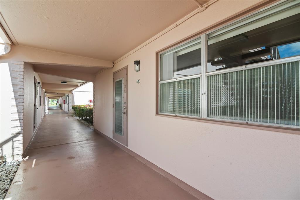 352 Saxony Trail, Unit 352 Delray Beach, FL 33446 - Photo 15 of 17 a view of a hallway with wooden floor and a window