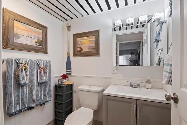 a bathroom with a sink toilet and mirror