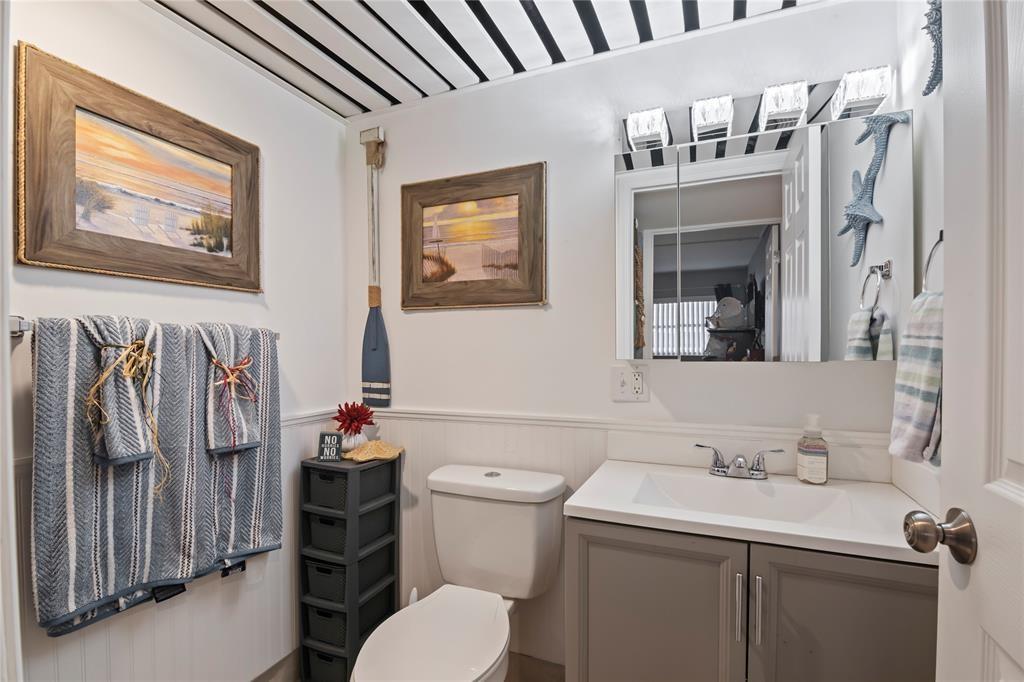 352 Saxony Trail, Unit 352 Delray Beach, FL 33446 - Photo 8 of 17 a bathroom with a sink toilet and mirror