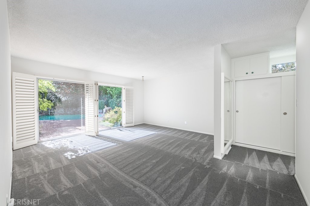 3949 Ballina Drive Encino, CA 91436 - Photo 19 of 31 a view of an empty room with wooden floor and a window
