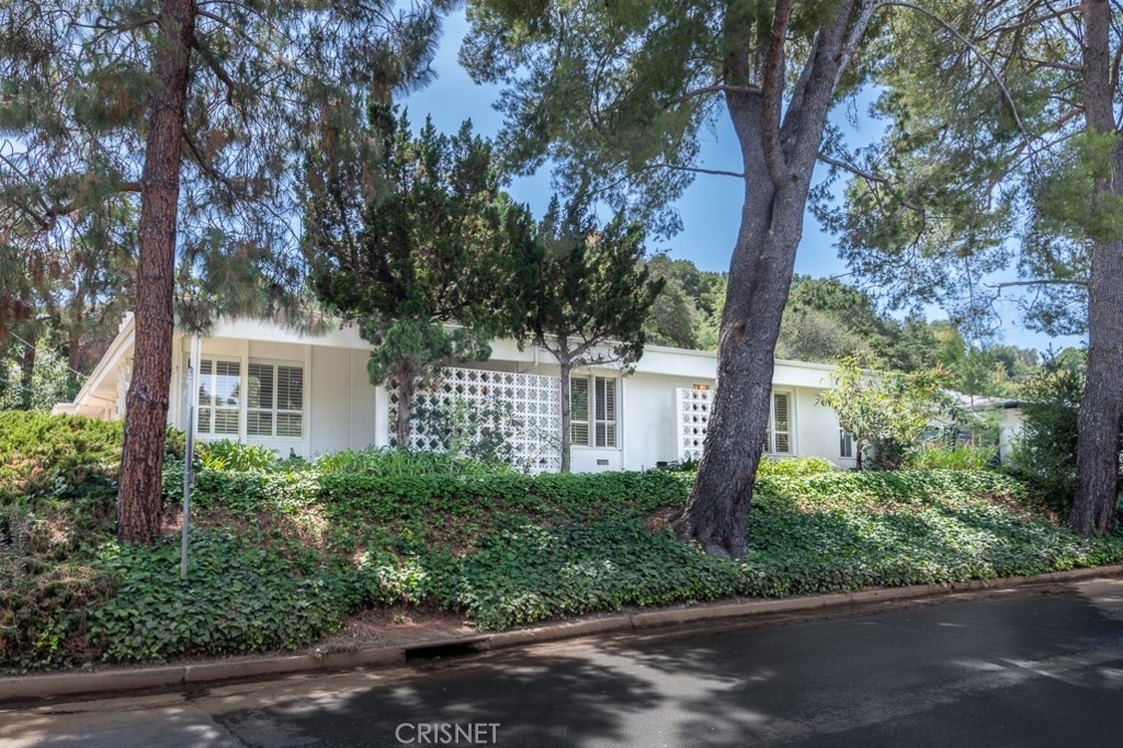 3949 Ballina Drive Encino, CA 91436 - Photo 2 of 31 a front view of a house with trees and plants