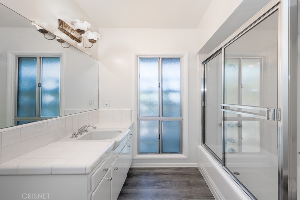 3949 Ballina Drive Encino, CA 91436 - Photo 22 of 31 a bathroom with a double vanity sink and mirror