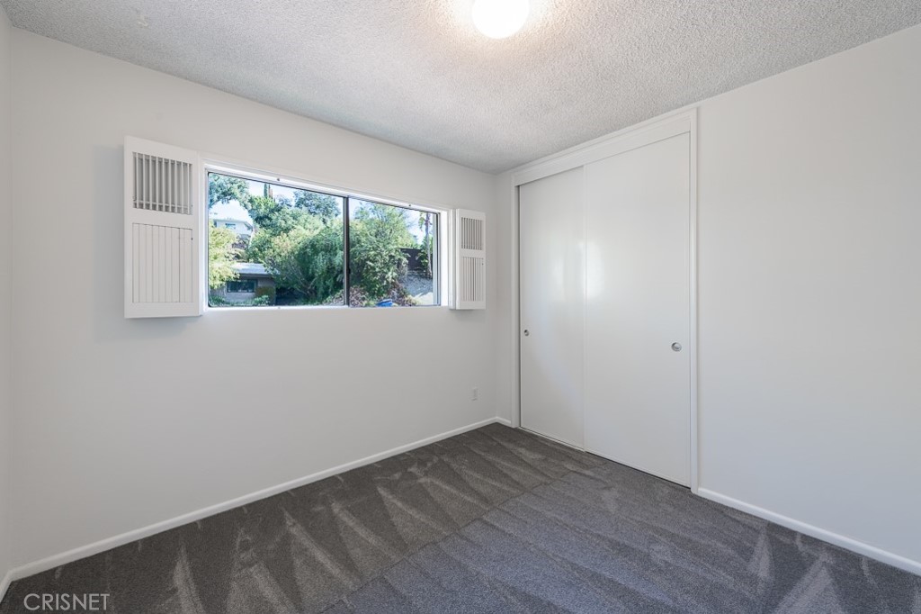 3949 Ballina Drive Encino, CA 91436 - Photo 24 of 31 an empty room with wooden floor and windows