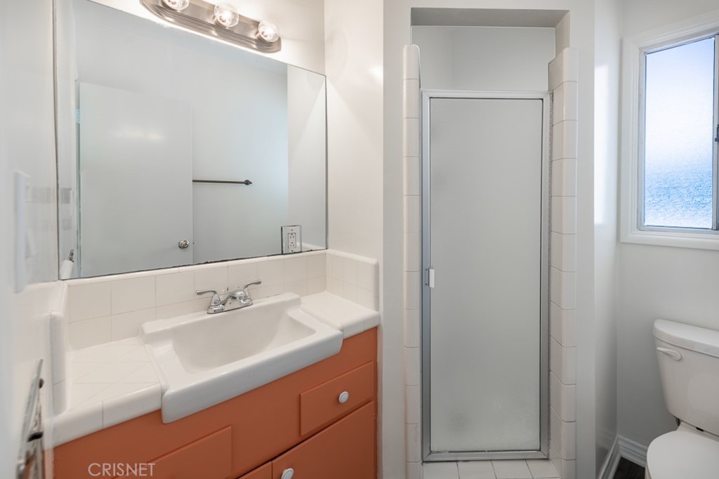 3949 Ballina Drive Encino, CA 91436 - Photo 25 of 31 a bathroom with a sink a toilet and shower