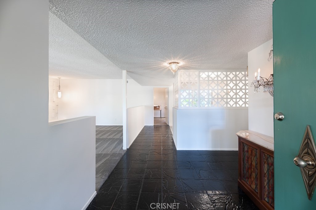 3949 Ballina Drive Encino, CA 91436 - Photo 5 of 31 a view of a hallway with wooden floor and staircase