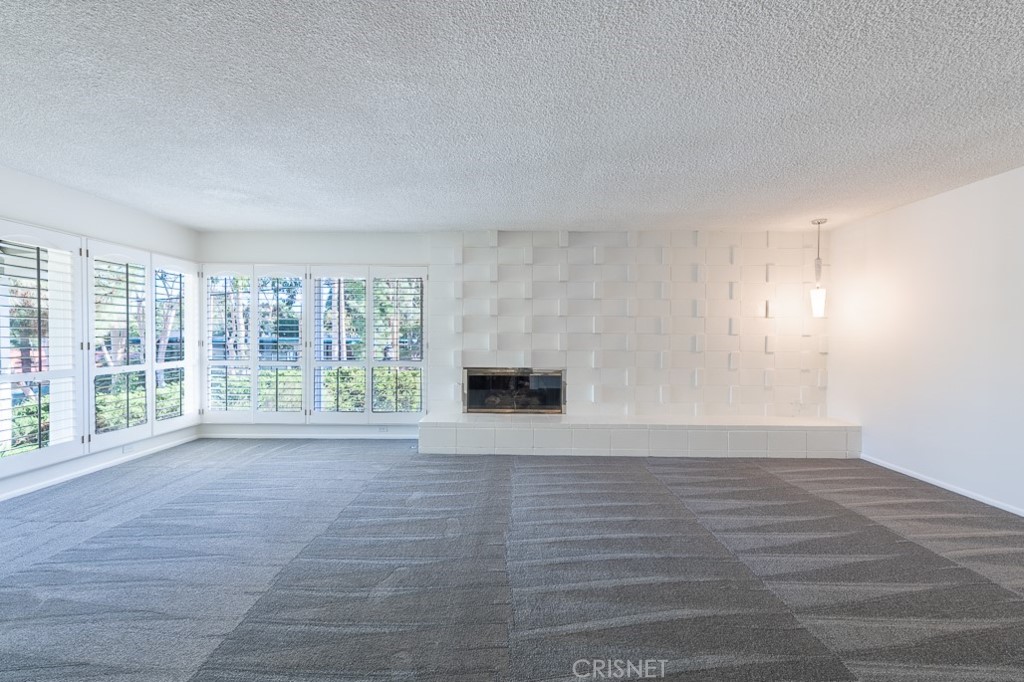 3949 Ballina Drive Encino, CA 91436 - Photo 7 of 31 a view of empty room with wooden floor and fireplace
