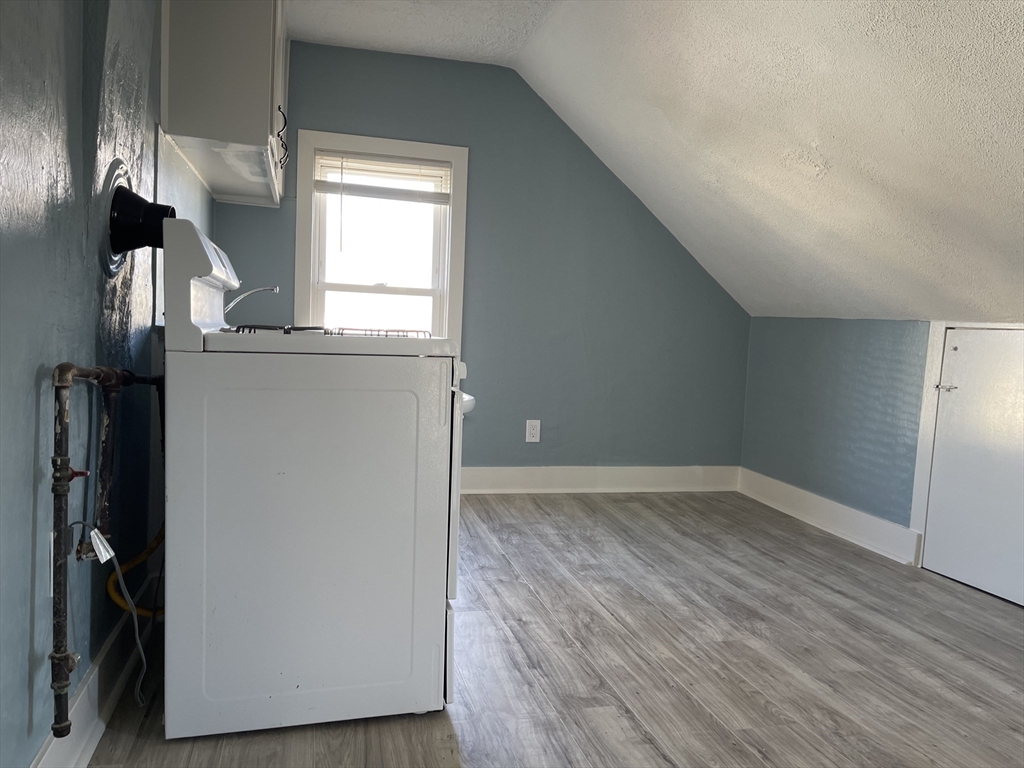 24 Union Street, Unit 3 Taunton, MA 02780 - Photo 6 of 10 a view of empty room with wooden floor and fan