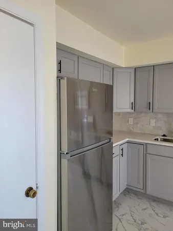 a kitchen with cabinets and stainless steel appliances