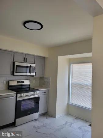 a kitchen with a stove and a microwave
