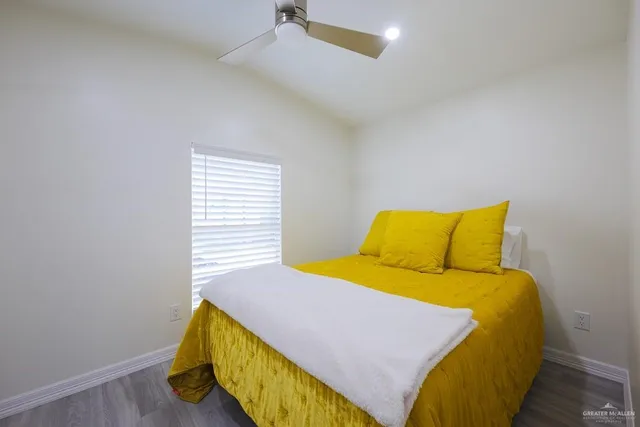 a bed room with a bed and a night stand