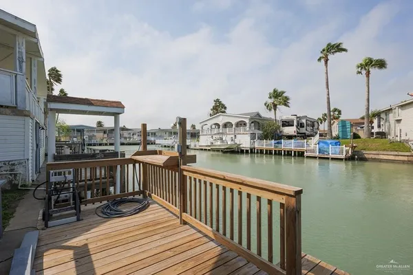 a view of a lake with boats and palm trees
