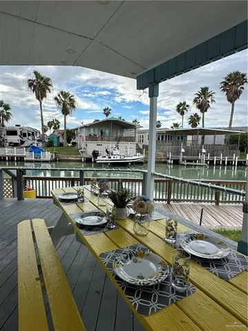 a view of a patio with couches table and chairs and potted plants