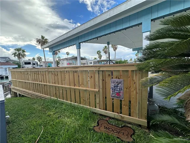 a view of a balcony with wooden floor and fence