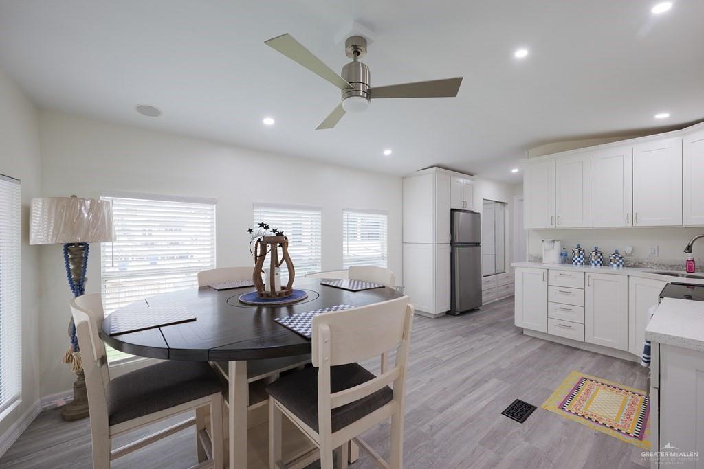 87 Abalone Circle Port Isabel, TX 78578 - Photo 5 of 40 a kitchen with a table chairs refrigerator and cabinets
